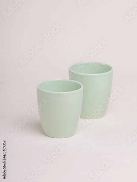 Obraz green ceramic cup on a light background