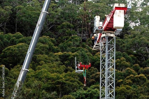 Fototapeta 9:09 am December 7, 2021: Tower Crane disassembly. (Removing Trolly Section) on the social housing at 56-58 Beane St. Gosford, NSW, Australia.