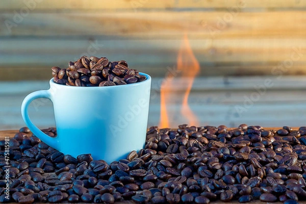 Fototapeta Coffee cup on a background of wood and fire