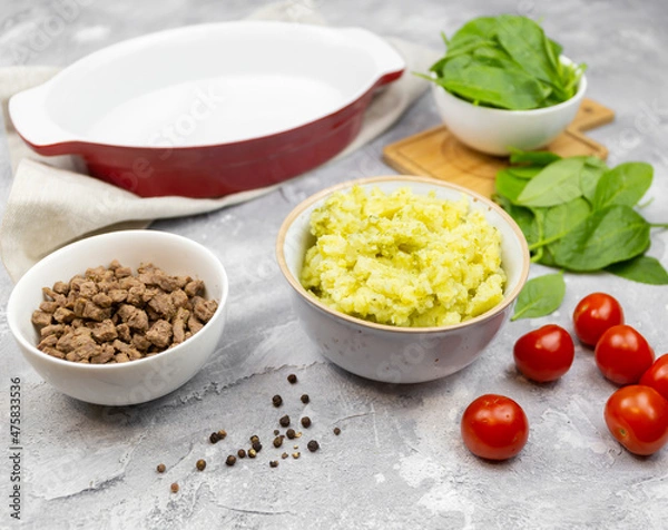 Fototapeta mashed potatoes, minced meat, tomatoes and spinach on the table