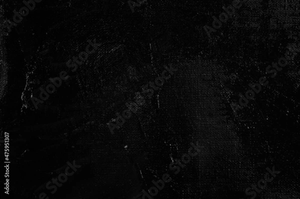 Fototapeta Dark creative background - rough linen canvas unevenly covered with black primer, reflections of light. Toning, blurring, selective focus.