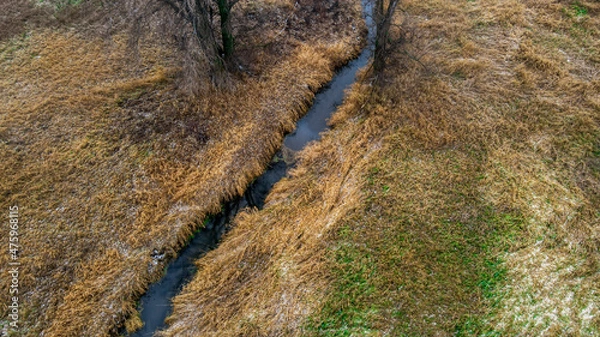 Fototapeta Blue stream flows through rural wisconsin farm lands in autumN