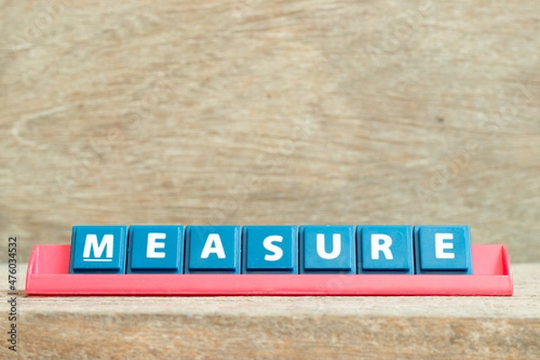 Obraz Tile alphabet letter with word measure in red color rack on wood background