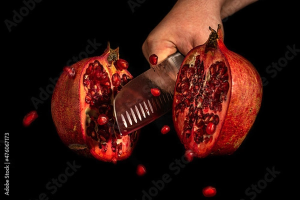 Obraz Pomegranate fruit chopped in flight. Dynamic studio shot. Selective focus.