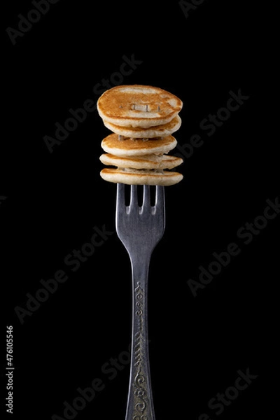 Obraz Tiny pancake on a fork on a dark background