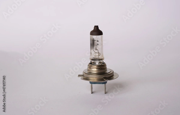 Fototapeta Halogen light bulb that is mainly used for headlights on a car. This picture shows a bulb that is blown and no longer works. You can clearly see the filament broken. 