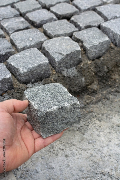 Obraz worker shows how a setts are worked to regular shape, distinct from a cobblestone
