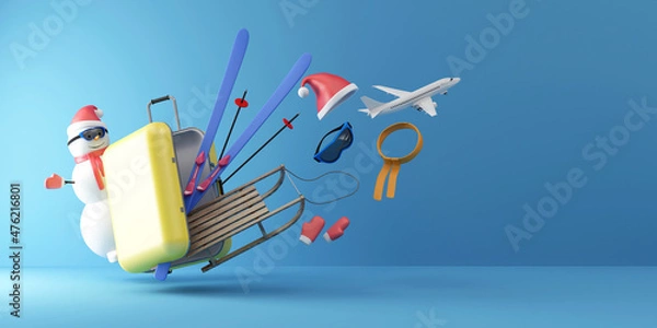 Fototapeta Winter Vacation Concept. Suitcase with Different Accessories for Winter with Snowman on blue studio background