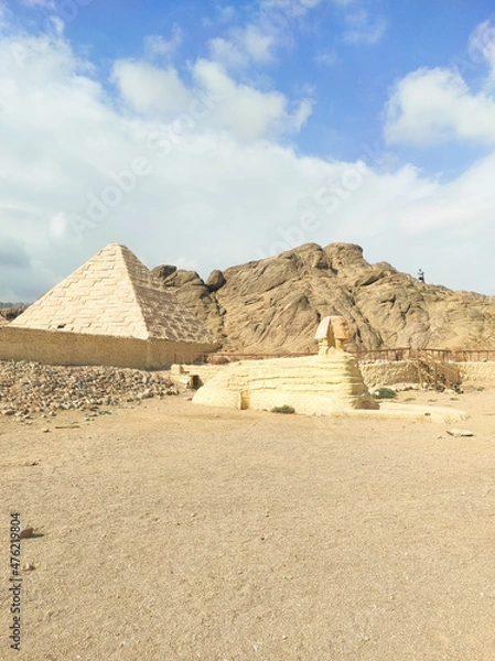 Fototapeta Pyramids in Egypt, ancient buildings and monuments. Statues in mini Cairo.