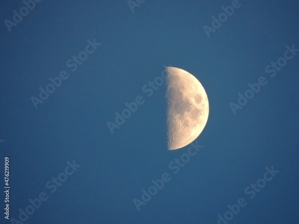 Fototapeta The moon on a blue background (sky). Macro photography with a zoom lens.