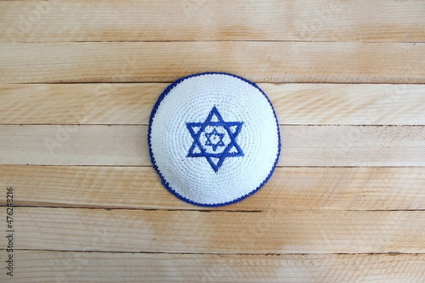 Obraz Jewish kippah hat with star of David on wooden background with a copy space