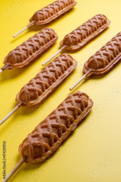 Fototapeta waffles sticks plains on yellow background. making patterns