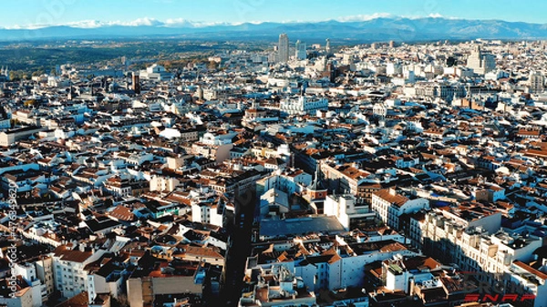 Fototapeta Amazing views of Madrid, Spain detailed architecture from the upside shot by flying drone brown roofs white walls capital metropolis blue sky cars vehicle beatiful buildings patterns