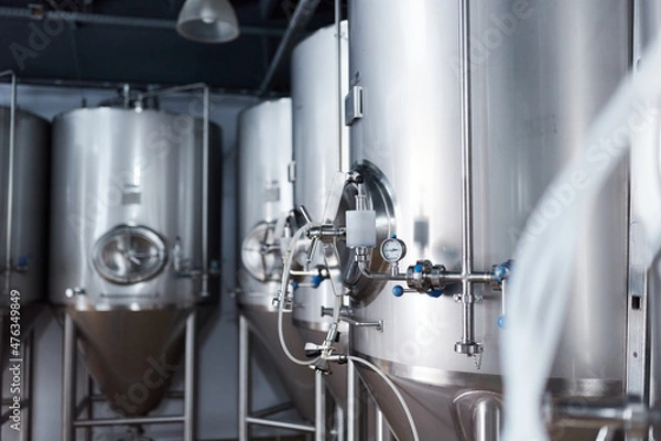Fototapeta Equipment for the production of craft beer, containers for fermentation in the climatic chamber, pressure gauge with tubes and stainless steel tanks.