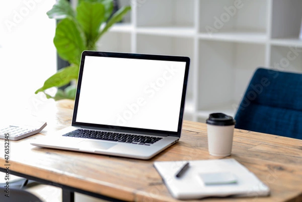 Fototapeta Laptop computer with blank white screen on table.