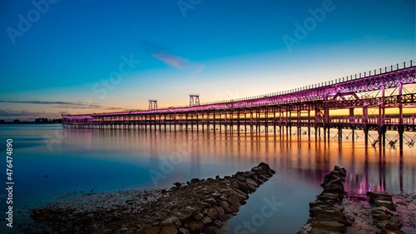 Fototapeta Panoramic view of the ore loading dock of the Rio Tinto mining company in Huelva, Andalusia, Spain. Sunset at the "Muelle del Tinto"