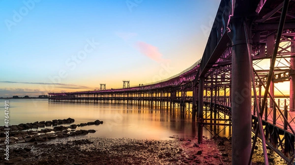 Fototapeta Panoramic view of the ore loading dock of the Rio Tinto mining company in Huelva, Andalusia, Spain. Sunset at the Muelle del Tinto