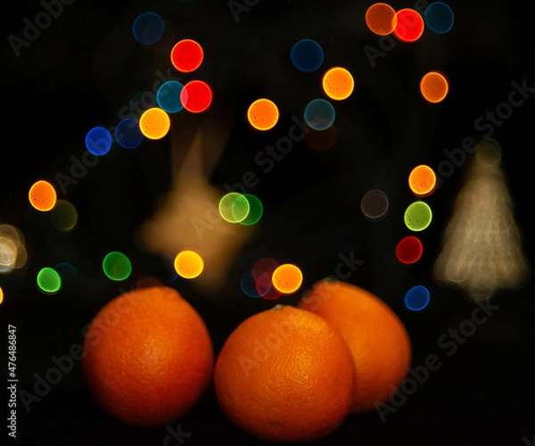 Fototapeta new year tangerines and garlands with bokeh