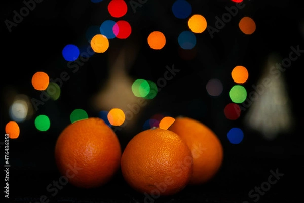 Fototapeta new year tangerines and garlands with bokeh