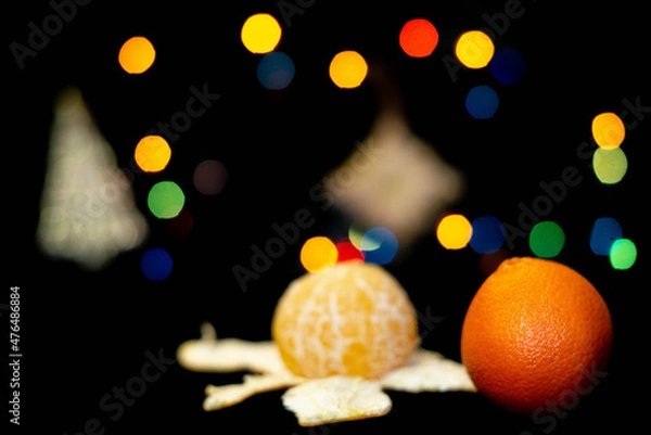 Fototapeta new year tangerines and garlands with bokeh