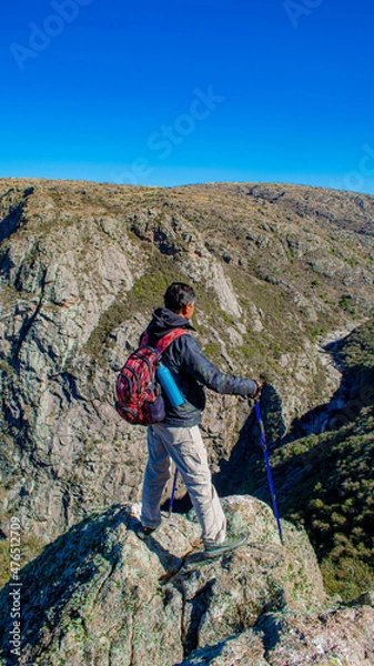 Obraz elderly person trekking looking towards the mountain