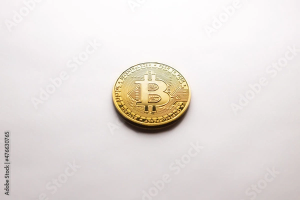 Fototapeta A single Bitcoin gold coin on a white background, as a product shooting
