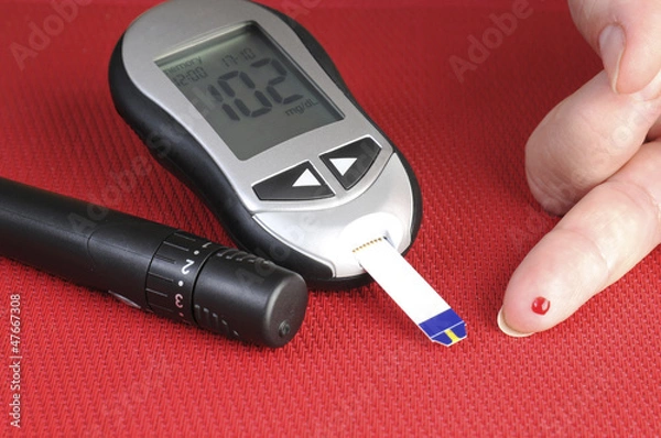 Fototapeta glucometer, with a 102 reading displayed.
