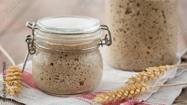 Fototapeta Active rye sourdough starter in a jar. Copy space.