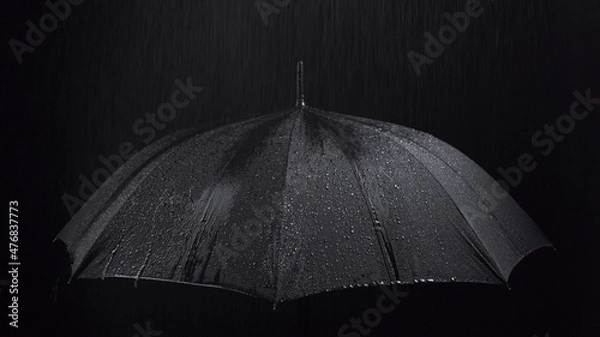 Obraz Photo of the black umbrella and rainy drops on black background