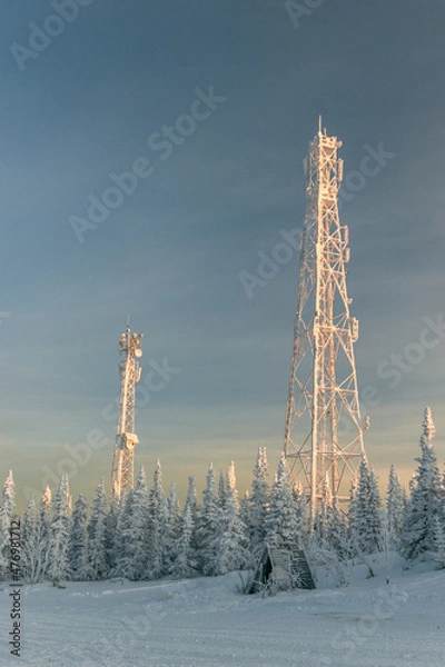 Fototapeta Snow communication towers on the top of the mountain, surrounded by snowy Christmas trees