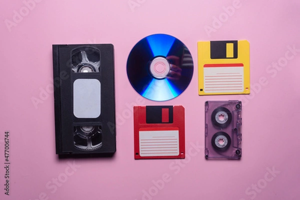 Fototapeta VHS, audio cassette, compact disk and floppy disk background.