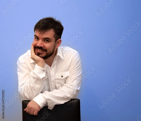 Obraz Young bearded man holding his face with one hand