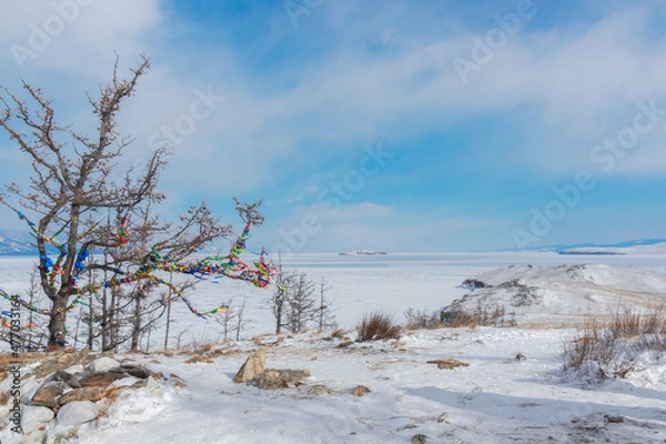 Fototapeta Winter landscape. A ritual site at the top of Ogoy Island. View of the mountains and frozen Lake Baikal on a winter day
