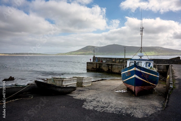 Obraz The pier on Rinroe point, Ireland. A fisherman is fishing with his rod.