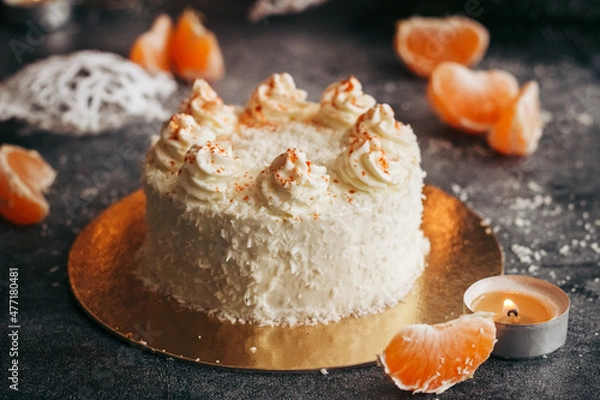 Fototapeta Christmas cake. Delicious cake with winter decor. Cake with tangerines on the table 