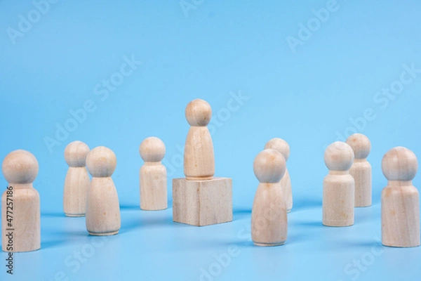 Obraz Women  icon on a wooden cube over the other men icon. leadership concept