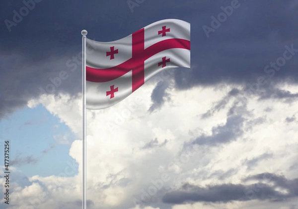 Fototapeta Flag of the Georgia, on a stick, dark clouds in the background