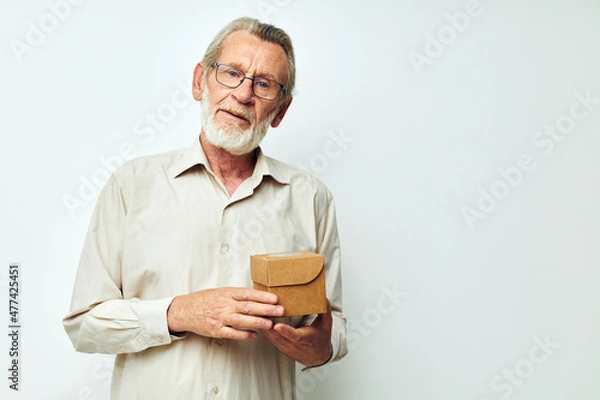 Obraz Old man demonstrates a box in studio one