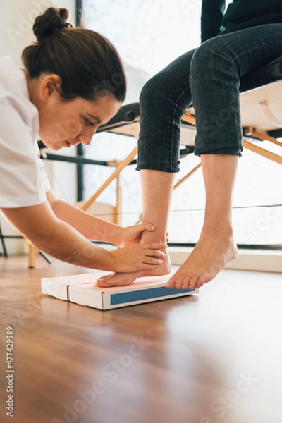 Fototapeta Chiropodist taking the shape of a patient's foot with a foam mold for the manufacture of a special insole.