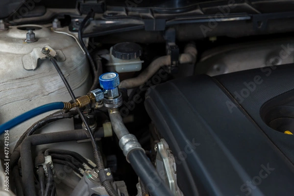 Fototapeta Auto mechanic monitor to check and fixed car air conditioner system in car garage. service car air conditioner in repair workshop. monitor tool on car engine ready to check and fixed air conditioner