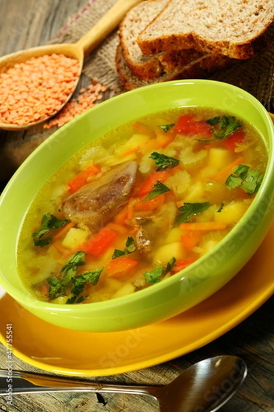 Fototapeta Chicken soup with red lentils.