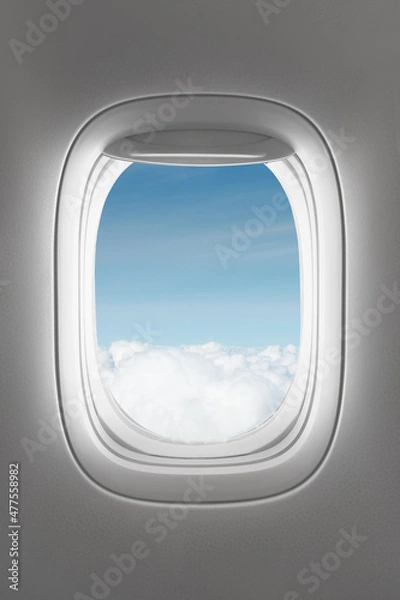 Fototapeta looking through a big jet passenger plane window, above the clouds