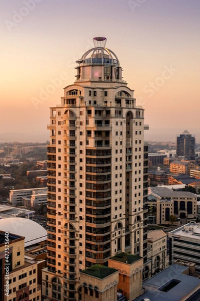 Fototapeta A vertical sot of the Michelangelo towers in Sandton, Johannesburg taken on a clear day during a golden sunset using a vertical composition. 