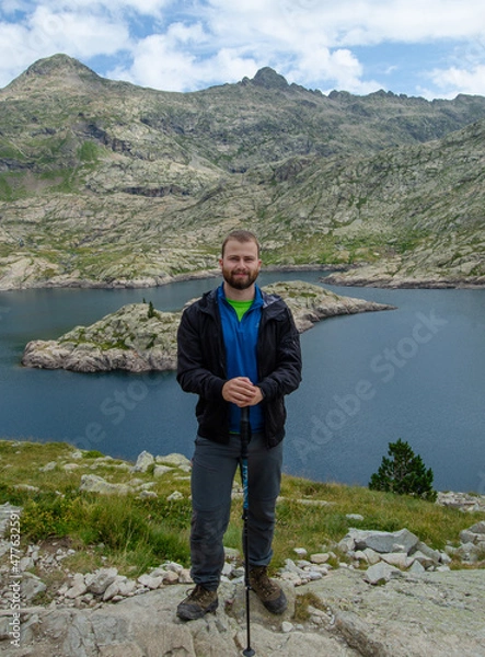 Fototapeta A man posing at a lake in the mountain ,