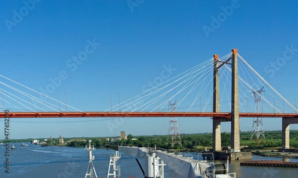 Fototapeta passing zarate brazo largo bridge with a big merchant vessel