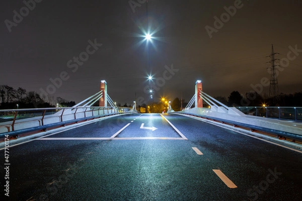 Fototapeta Bridge with busy street and traffic lights at night