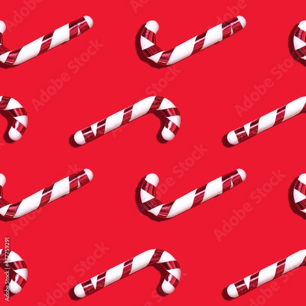Fototapeta Santa's red-white candy cane seamless pattern on a red background.