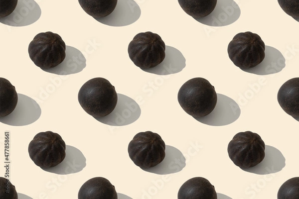 Fototapeta Black whole dried limes. Dried Lime is a spice used in Middle Eastern dishes. Seamless repeating pattern.