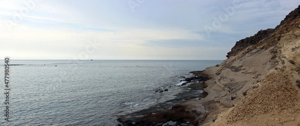 Fototapeta Panoramic view of a stretch of southern coast on the island of Tenerife with slopes and a view of the open sea in cloudy weather