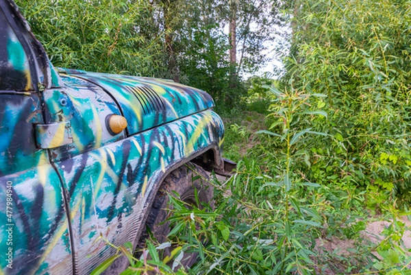 Obraz Old SUV stuck in the forest